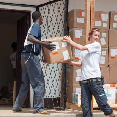 People unloading van with boxes for Médecins Sans Frontiers.