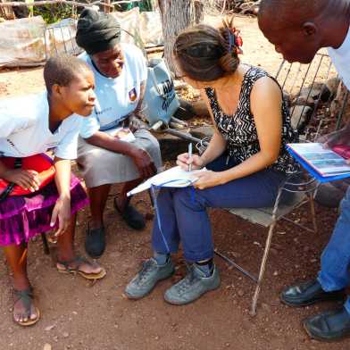 Scientist in exchange with local volunteers in Zimbabwe.