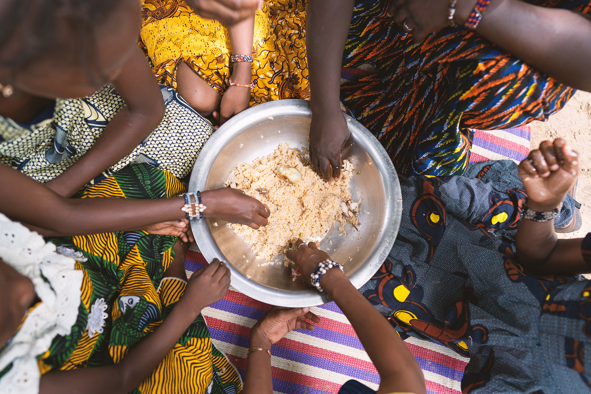 African girls sharing a meal
