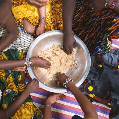 African girls sharing a meal.