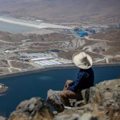 Man from the Huancuire community (Peru) that is impacted by the activities of the Las Bambas mining company, looking down on the mining site.  